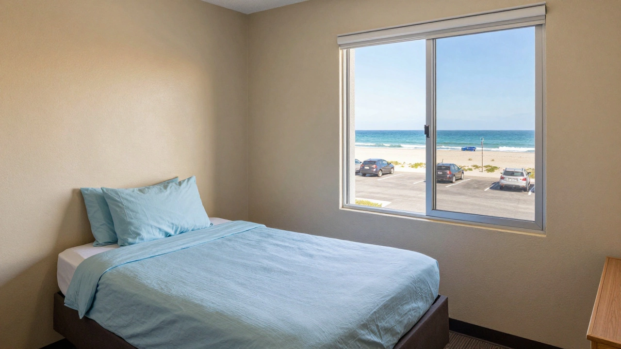 A clean, simple motel room with ocean view and free parking outside.