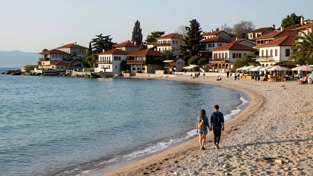 Couple walking on a quiet, affordable European beach during shoulder season